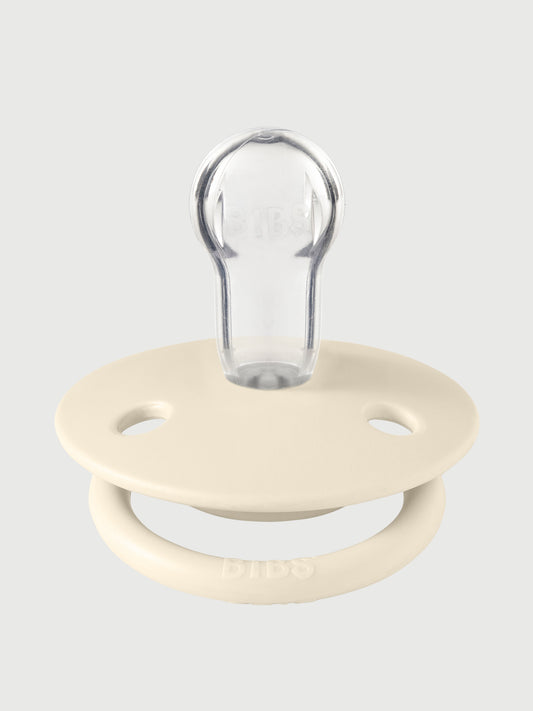 Ivory pacifier with a clear, rounded silicone nipple and a smooth, natural-looking ring handle designed for premium kvalitet . - BIBS De Lux Onesize Ivory